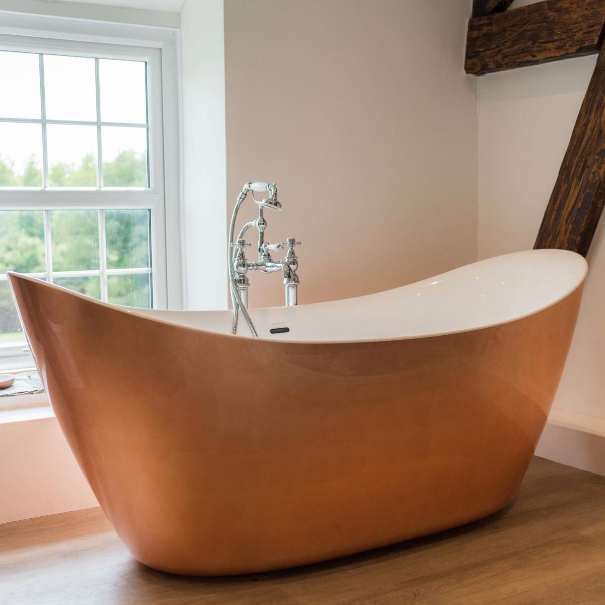 A bath in front of the window inside the cottage at Wooladon Estate