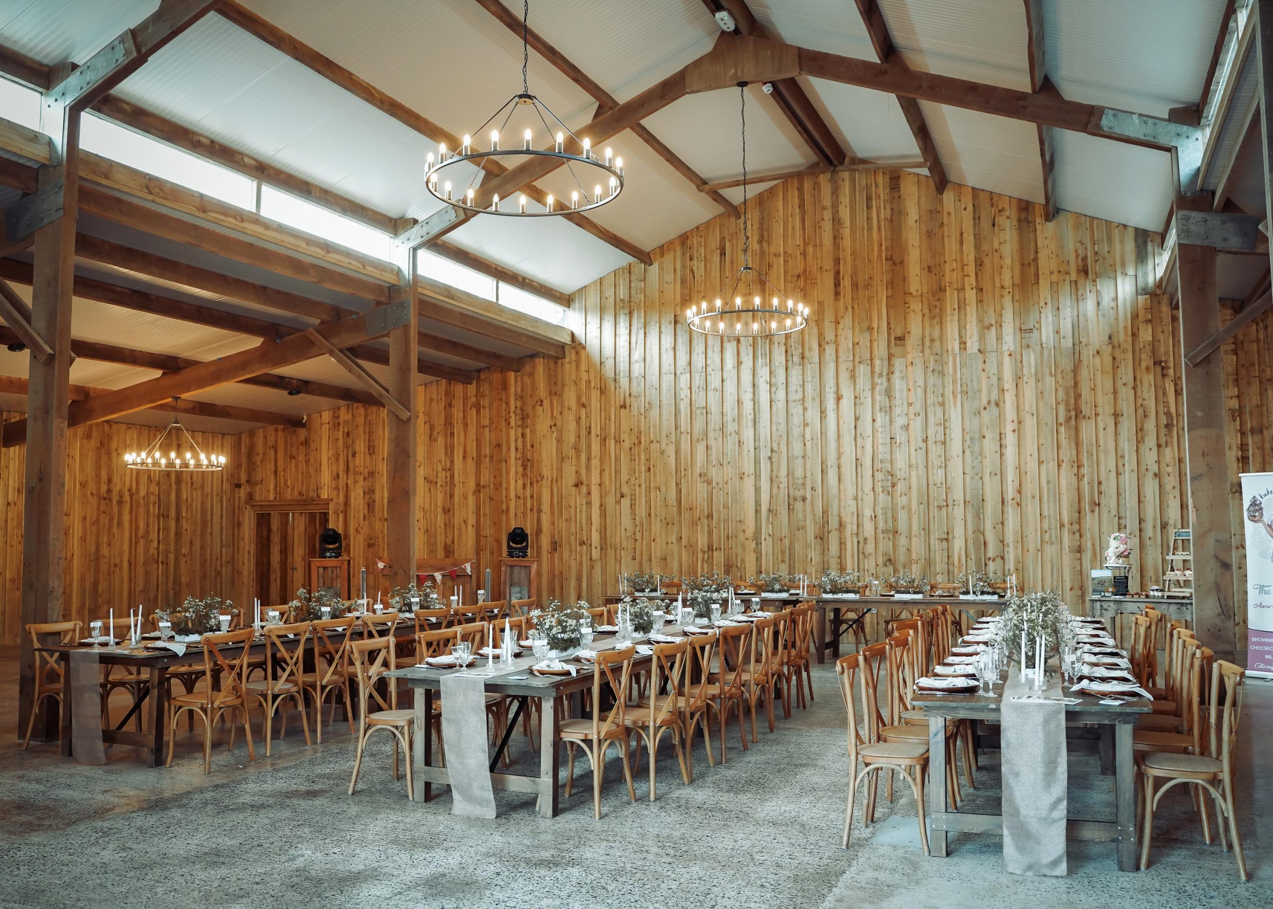 The barn at Wooladon Estate set up for a wedding reception with rows of tables and decorations