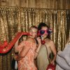 Guests wearing large sunglasses and holding props for photographs at a wedding reception in the barn at Wooladon Estate